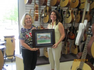 Jan Gerfen being presented a framed print by artist Richelle Flecke 