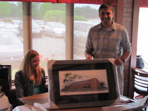 Jonathan Collar unwrappping Hinkle Fieldhouse framed artwork